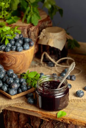 Photo for Blueberry jam with fresh berries on an old wooden table. - Royalty Free Image