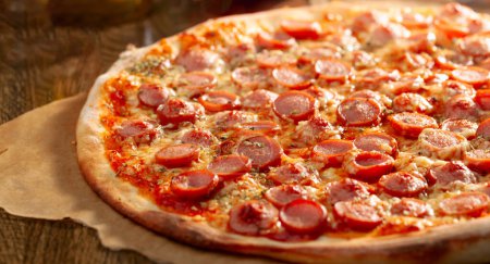 Photo for Tasty fresh backed pizza with sausages and spices. Selective focus. - Royalty Free Image