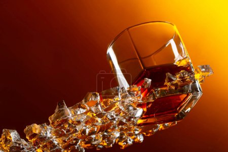 Photo for Whiskey with ice on a glass table in bar. View from the bottom. - Royalty Free Image