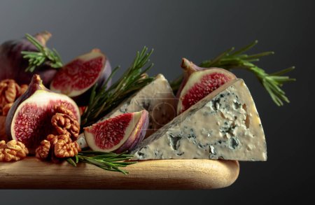 Téléchargez les photos : Fromage bleu aux figues, noix et romarin sur une table en bois. - en image libre de droit