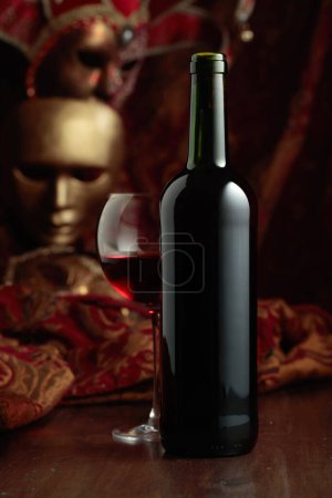 Photo for Still life with red wine and vintage carnival masks. - Royalty Free Image