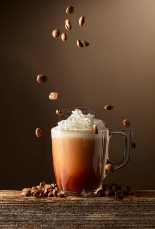 Photo for Coffee and chocolate drink with whipped cream on a brown background. Copy space. - Royalty Free Image