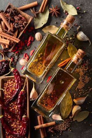Photo for Bottles of olive oil and various spices on a kitchen table. Top view. - Royalty Free Image
