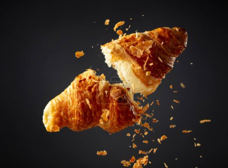 Photo for Fresh baked croissant in air on a black background. - Royalty Free Image