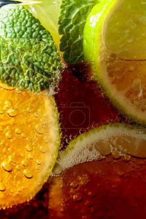 Photo for Carbonated drink with mint and lime slices. Macro shot. - Royalty Free Image