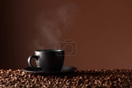 Photo for Black cup of coffee on the table with scattered beans. Copy space. - Royalty Free Image