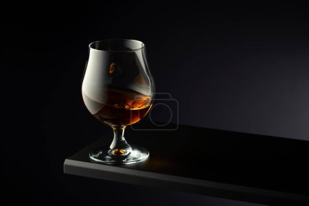 Photo for Brandy snifter on a dark background. Copy space. - Royalty Free Image