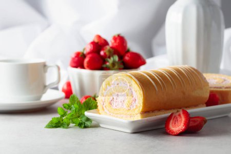 Photo for Homemade strawberry biscuit cake roll with cream cheese, whipped cream, and fresh berries. Delicious biscuit cake with strawberries on a white table. - Royalty Free Image