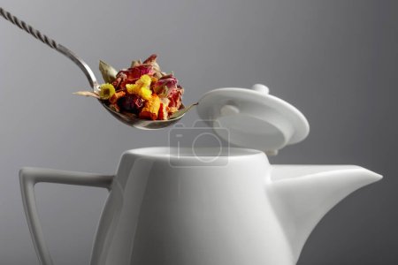 Photo for The mix of dried herbs and flowers is poured into the teapot. Selective focus. - Royalty Free Image