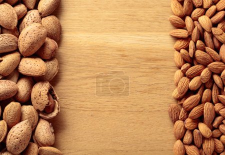 Photo for Almonds on a wooden background. Top view with copy space. - Royalty Free Image