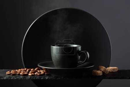Photo for Cup of black coffee with coffee beans and brown sugar. Coffee with ingredients on a black background. - Royalty Free Image