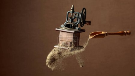 Photo for Pepper powder is poured out of the wooden spoon. Old pepper grinder and a wooden spoon with pepper ground. Copy space. - Royalty Free Image