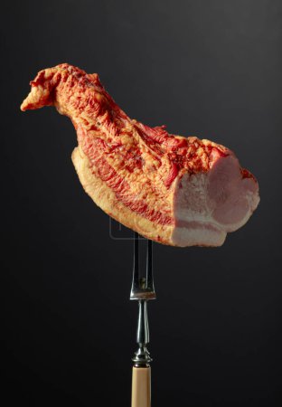 Photo for Piece of smoked pork on a fork. - Royalty Free Image