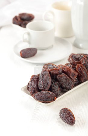Photo for Dried medjool dates on a white kitchen table. - Royalty Free Image