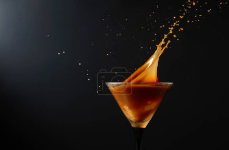 Photo for Chocolate martini drink with splashes on a black background. Copy space. - Royalty Free Image