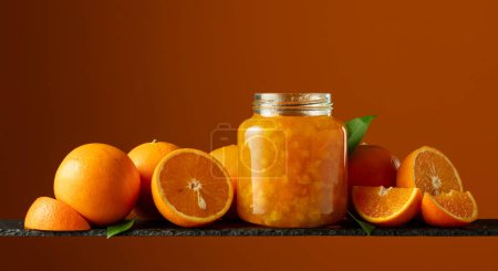 Photo for Orange jam in glass jar and fresh fruits. Copy space. - Royalty Free Image