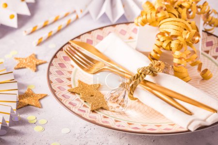 Photo for Festive place setting for Christmas and New Year with paper  fans in golden tone - Royalty Free Image