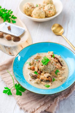 Photo for Homemade Bavarian bread dumpling, called in south Germany as Semmelknoedel with creamed mushroom sauce - Royalty Free Image