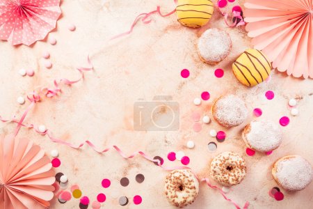 Photo for Traditional Berliner for carnival and party. German Krapfen or donuts with streamers and confetti. Colorful carnival or birthday image - Royalty Free Image