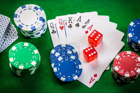 Téléchargez les photos : Playing cards, dice and poker chips , casino poker chips on green background - en image libre de droit