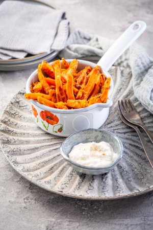 Téléchargez les photos : Homemade sweet potato and carrot fries with parmesan cheese and lemon yogurt dip - en image libre de droit