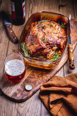 Téléchargez les photos : Roasted pork meat with potatoes, rosemary and beer sauce in casserole - en image libre de droit