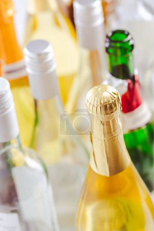 Téléchargez les photos : Full and empty bottles of different alcoholic drinks, abuse and alcohol addiction. Alcoholism concept. - en image libre de droit