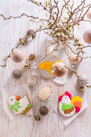 Foto de Galletas de jengibre de huevo de Pascua con ramas. Concepto primavera. - Imagen libre de derechos