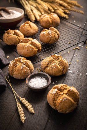 Photo for Homemade spelt bread rolls with salt on wooden background - Royalty Free Image
