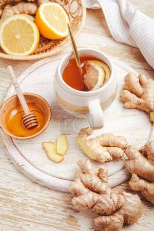 Photo for Ginger tea with lemon and honey on a wooden table - Royalty Free Image