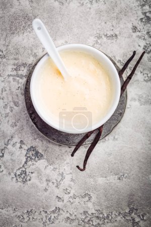 Photo for Homemade vanilla sauce in small bowl on grey background - Royalty Free Image