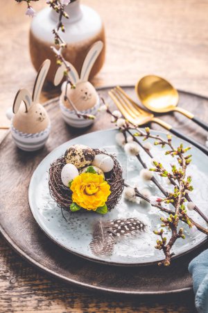 Photo for Easter table setting with spring flowers and cutlery on wooden table.  Spring Easter Holiday Table - Royalty Free Image