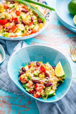Photo for Mexican quinoa black bean salad with fresh tomatoes, cucumbers, onion and cilantro - Royalty Free Image