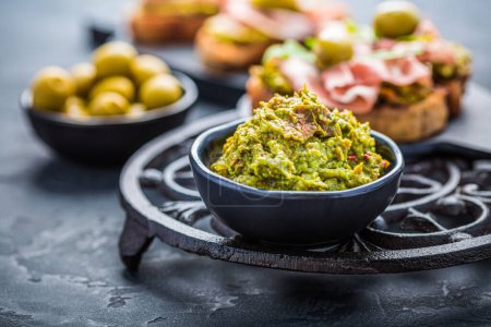 Photo for Avocado spread, guacamole with fried bread, substitute for toast and olives - Royalty Free Image