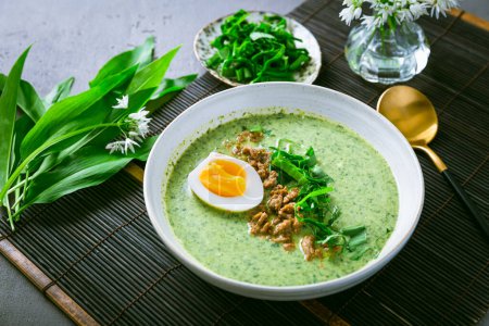 Photo for Wild garlic soup, bear leek soup (ramson soup) with boiled egg - Royalty Free Image