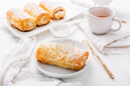 Photo for Homemade apple strudel with cinnamon, apple pie with cup of fruit tea - Royalty Free Image