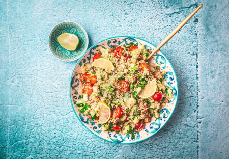 Photo for Tabbouleh salad, traditional middle eastern and arab dish. Levantine vegetarian salad with parsley, mint, bulgur, tomato and cucumber - Royalty Free Image