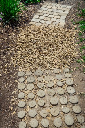 Photo for Garden path made of natural wooden planks, stones,  gravel. Healthy sensory path with different surfaces. - Royalty Free Image