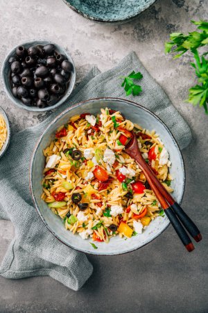Photo for Homemade orzo pasta salad with feta, olives, tomatoes - Royalty Free Image