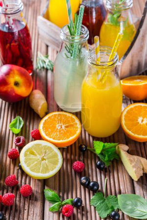 Photo for Prepaing refreshing summer drinks and lemonade with fruits and berries - Royalty Free Image