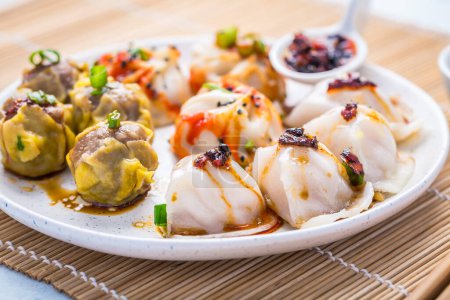 Photo for Assortment of steamed dumplings Dim Sum on kitchen table - Royalty Free Image