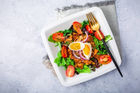 Photo for Summer mixed salad with roaster chanterelles mushrooms, tomato and egg - Royalty Free Image