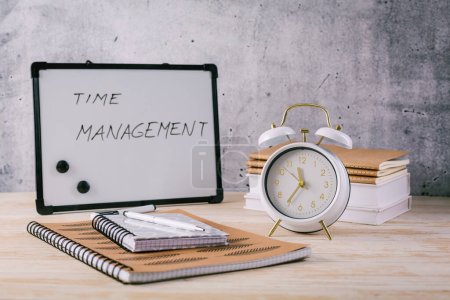 Photo for Alarm clock and books - time management and procrastination concept - Royalty Free Image