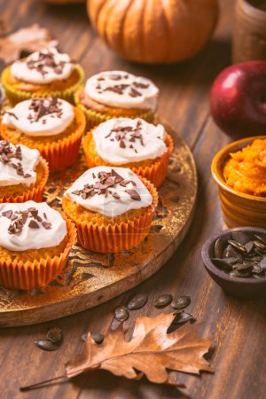 Photo for Spicy pumpkin muffins or cupcakes with cream cheese frosting - Royalty Free Image