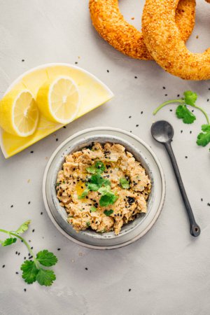 Photo for Vegan chickpea hummus spread with lemon and bagel - Royalty Free Image