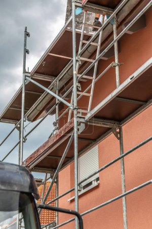 Photo for Modern house under construction with scaffold pole platform. New build domestic building - Royalty Free Image