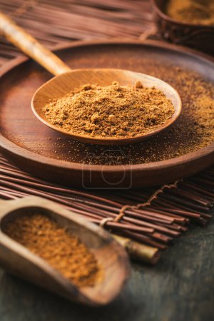 Photo for Organic coconut plam sugar in wooden scoop and bowl - Royalty Free Image