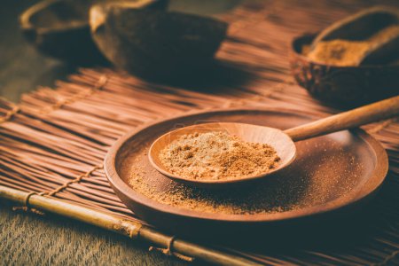 Photo for Organic coconut plam sugar in wooden scoop and bowl - Royalty Free Image