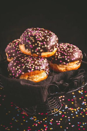 Photo for Berliner donuts, filled with jam and colorful confetti - Royalty Free Image