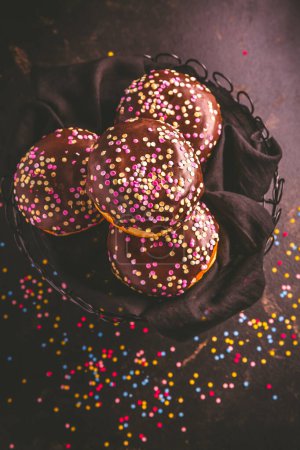 Photo for Berliner donuts, filled with jam and colorful confetti - Royalty Free Image